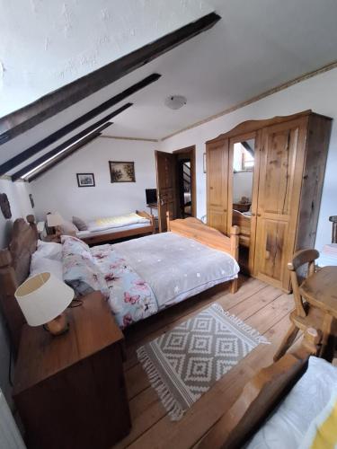a bedroom with a large bed and a wooden floor at Stara Vodenica in Klanjec