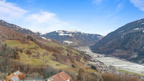 a view of a valley with a river and mountains at Gemütliche 2.5 Zimmer Wohnung mit privater Sauna in Seewis im Prättigau