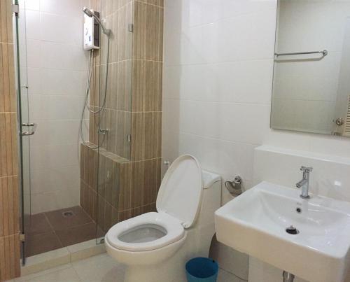 a bathroom with a toilet and a sink and a shower at The Garden Living in Bangkok