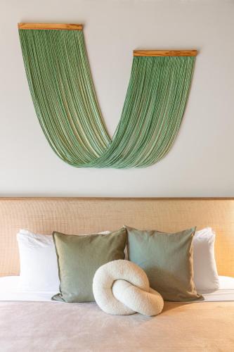 a bedroom with a bed with two towels on it at Villa Koa - Your Tropical Retreat in Santa Teresa Beach
