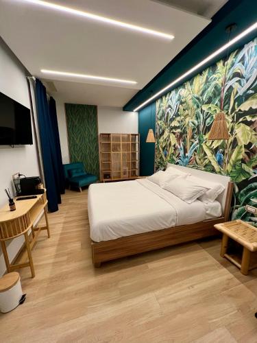 a bedroom with a bed and a painting on the wall at Eterna Suites Roma in Rome