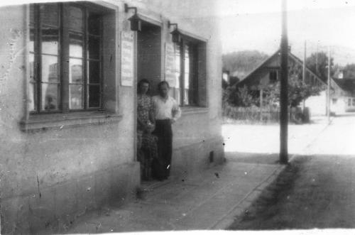 two people are standing outside of a building at Hotel Beskid in Milówka