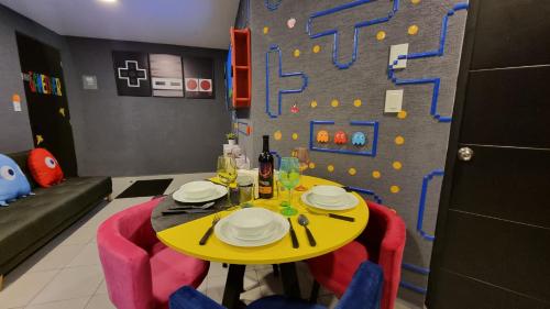a dining room with a yellow table and a climbing wall at Departamento Zona Gamer Frente al Aeropuerto in Mexico City