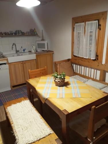 a kitchen with a wooden table with a table sidx sidx sidx at Drevenica Traditional Cottage Old Centre in Zuberec