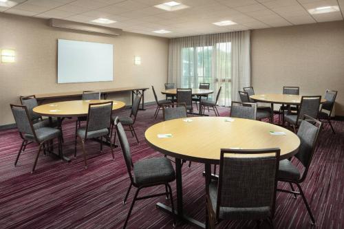 a conference room with tables and chairs and a whiteboard at Courtyard Costa Mesa South Coast Metro in Santa Ana