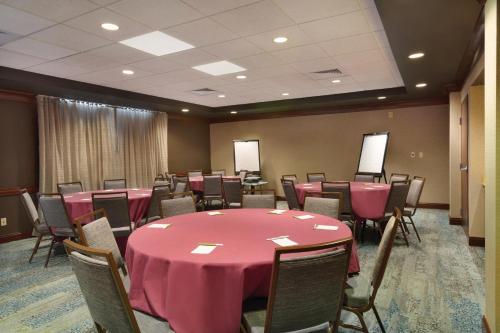 a conference room with a pink table and chairs at Courtyard by Marriott Fort Smith Downtown in Fort Smith