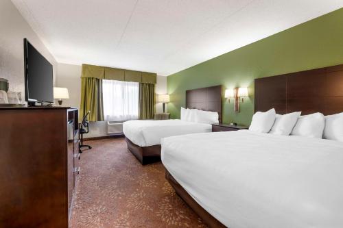 a hotel room with two beds and a flat screen tv at Best Western Plus New Ulm in New Ulm