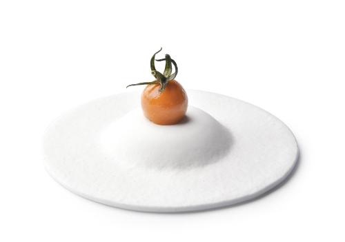 a tomato sitting on a white plate at Villa Petriolo - Small Luxury Hotels of the World in Cerreto Guidi