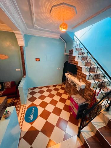 a room with a staircase with a checkered floor at fulki house in Taghazout