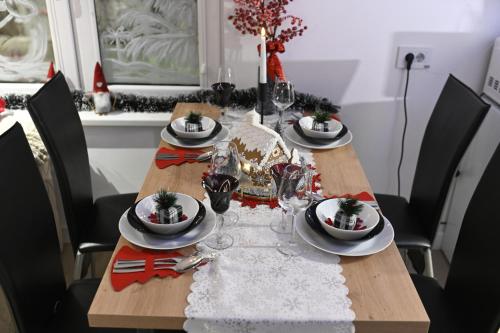 a dining room table with christmas decorations on it at Josephine Apartment in Subotica