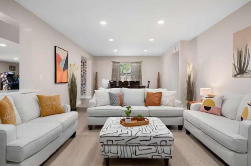 a living room with white couches and a table at 6 Br Resort Style Home Pool Game Room Fire Pit in Glendale