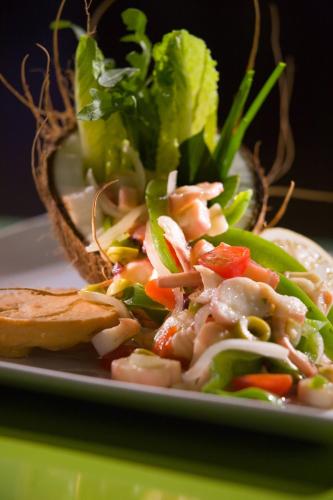 a plate of food with a salad and a sandwich at Courtyard by Marriott Isla Verde Beach Resort in San Juan