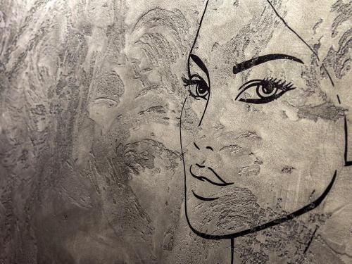 a drawing of a womans face on a wall at Luna Studios Zillertal in Hippach
