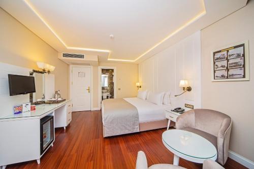 a hotel room with a bed and a desk at Ada Karakoy Hotel - Special Category in Istanbul
