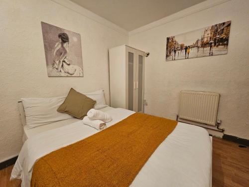a bedroom with a bed with a towel on it at London E14 Stay in London