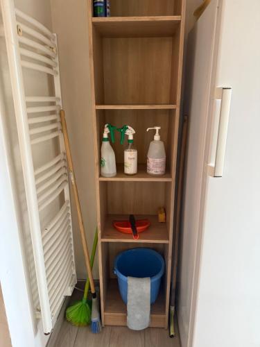 a closet with a broom and cleaning products in it at gites de Warincthun in Audinghen