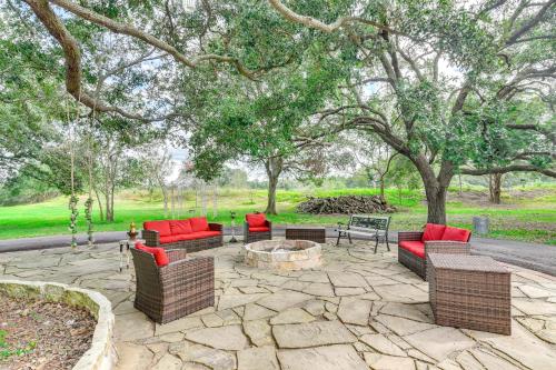 a patio with couches and a fire pit and trees at Family Home on 30 Acres in Manvel! in Manvel