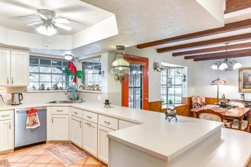 a kitchen with white cabinets and a dining room at Family Home on 30 Acres in Manvel! in Manvel