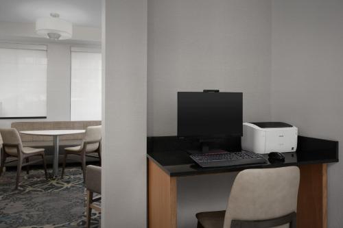 an office with a computer on a desk with chairs at Residence Inn Phoenix North Happy Valley in Phoenix