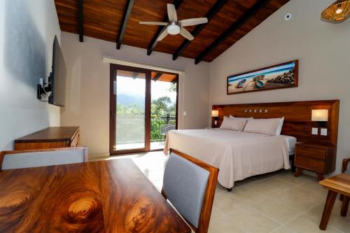 a bedroom with a bed and a table with a dining room at River Park Hotel in Puerto Vallarta