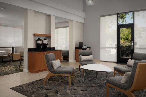 a waiting room with chairs and a table and a counter at Residence Inn Phoenix North Happy Valley in Phoenix
