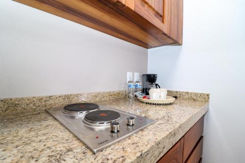 a kitchen counter with a stove top in a kitchen at River Park Hotel in Puerto Vallarta