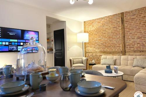 - un salon avec une table et un pot en verre dans l'établissement Les Bains de Trouville - Standing - Hypercentre, à Trouville-sur-Mer