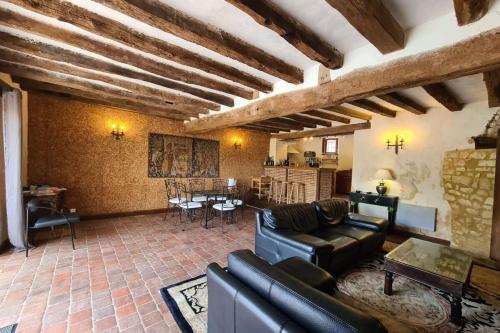 a living room with a couch and a table at La Bastide des Chézeaux - Brenne in Rivarennes