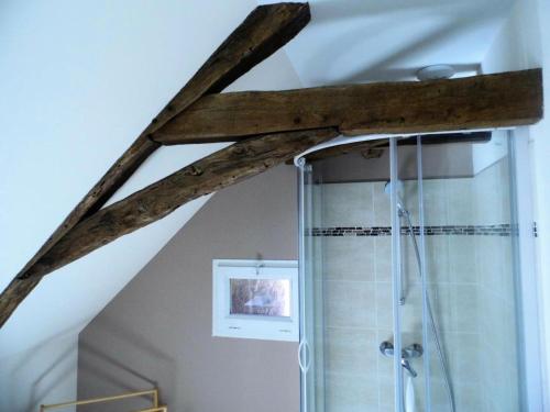 La salle de bains est pourvue d'une douche et d'un plafond en bois. dans l'établissement Gîte de France à Meyssac 4 épis - Gîte de France 12 personnes MAE-9024, à Meyssac