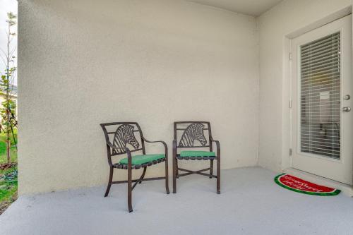 two chairs sitting on a porch next to a window at Playground Access Winter Haven Getaway with Patio! in Winter Haven