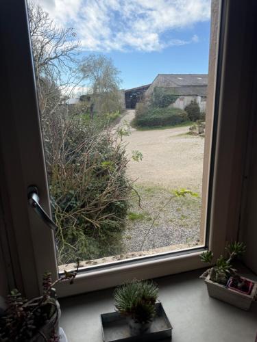 a window with a view of a field outside at gites de Warincthun in Audinghen