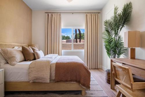 a bedroom with a large bed and a window at The Sunset Hideaway by Roav Retreats in Cathedral City