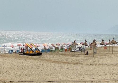 a group of umbrellas and chairs on a beach at Appartement complexe Costa Mar avec piscine privée très sécurisé 3min de la plage Luxe et détente in Martil