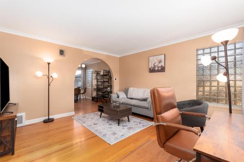a living room with a couch and a table at Charming Oak Park Retreat in Oak Park