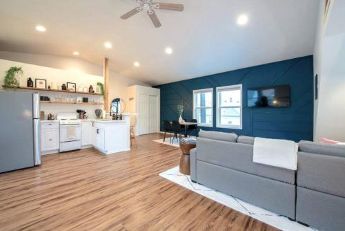 a living room with a gray couch and a blue wall at U-District Loft near GU w Self Check-in and Wifi in Spokane