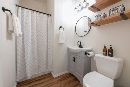 a bathroom with a white toilet and a sink at U-District Loft near GU w Self Check-in and Wifi in Spokane