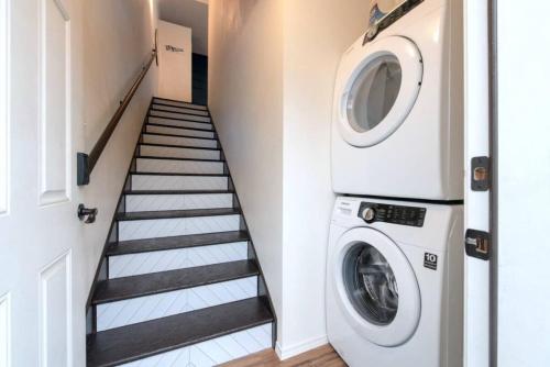 a laundry room with a washing machine and a staircase at U-District Loft near GU w Self Check-in and Wifi in Spokane