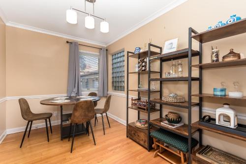 a dining room with a table and shelves at Charming Oak Park Retreat in Oak Park