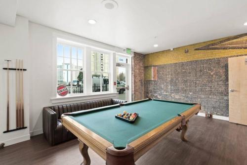 a pool table in a room with a couch at Roav Stays - J and K on Main Luxury Apartment 405 in Spokane
