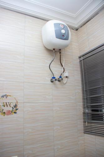 a security camera on the wall of a bathroom at Kenest Villa - 3 Master-Bedrooms in Oyarifa