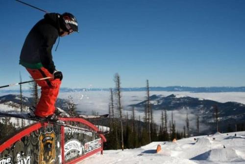 a person on skis jumping off a rail in the snow at Urban SoHo Suite in the Heart of Downtown in Spokane