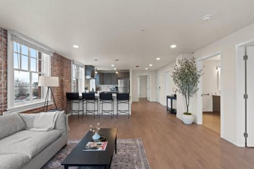 a large living room with a couch and a kitchen at Luxury w King Beds, Pool Table, Central Downtown! in Spokane