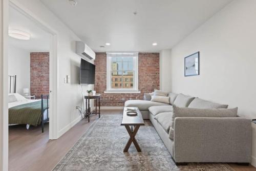 a living room with a couch and a bedroom at Walk to Riverfront Park! Downtown Gem w Pool Table 404 in Spokane