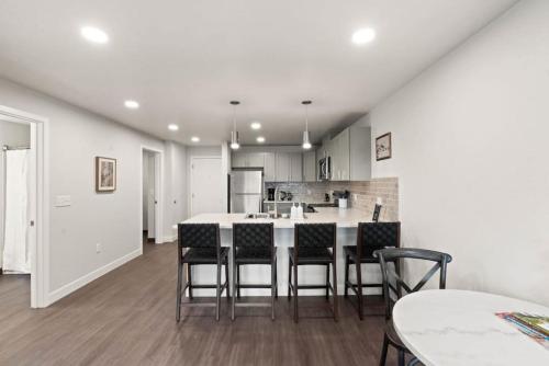 a kitchen with a table and chairs in a room at Spacious, King Bed, w Pool Table & Brunch Below! 303 in Spokane