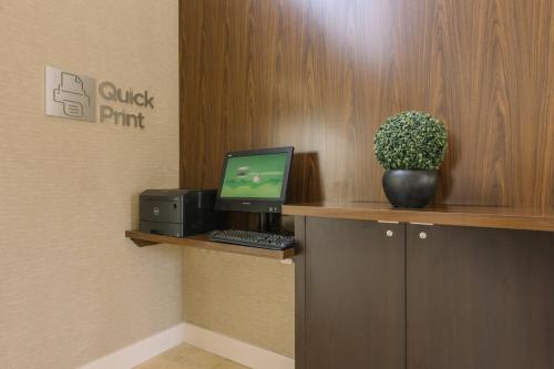 a office with a desk with a computer on a shelf at Courtyard by Marriott Nashua in Nashua