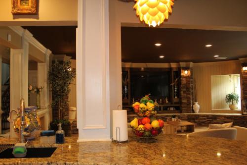 a kitchen with a counter with a bowl of fruit on it at Paradise Suite - Pueblo Bonito in McDonough
