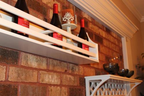 a brick wall with bottles of wine on it at Paradise Suite - Pueblo Bonito in McDonough
