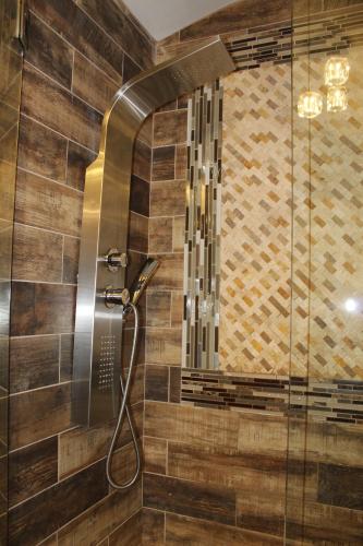 a shower with a glass door in a bathroom at Paradise Suite - Pueblo Bonito in McDonough