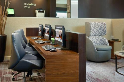an office with three computer monitors on a desk at Courtyard by Marriott Tallahassee Downtown/Capital in Tallahassee