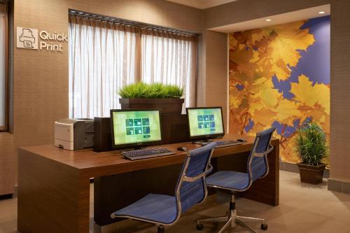 an office with two computer monitors on a desk at Courtyard by Marriott Toronto Downtown in Toronto